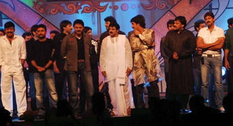 Nagarjuna pulls Chiru onto the "Star Night" dias.