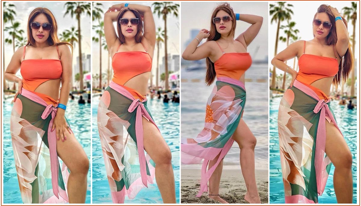 Neha Malik Dressed in a vibrant orange cutout monokini